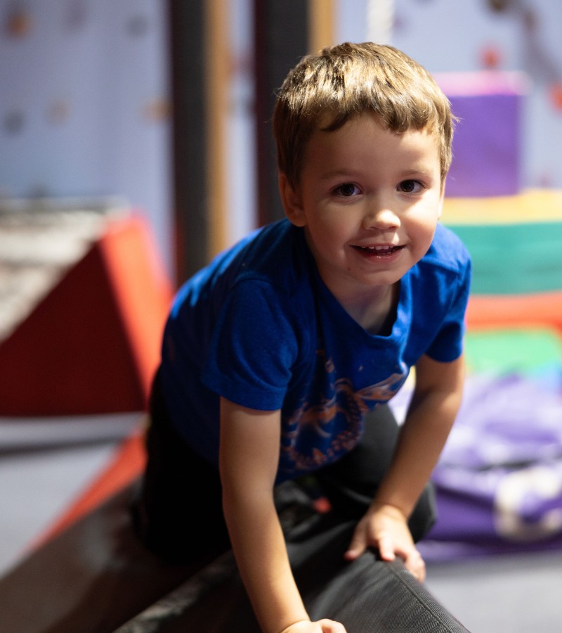 a kid plays in a gymnastics area at the workout club in manchester